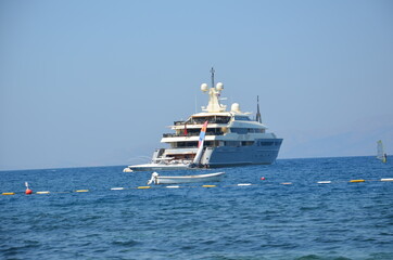 An ultra-luxury yacht anchored off the Aegean Sea.