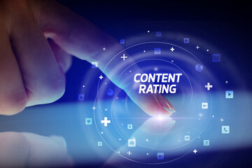Finger touching tablet with social media icons and CONTENT RATING