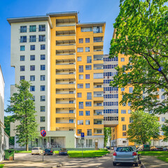 Modern city architecture of living complex. Sunny summer day. Exterior of residential building.