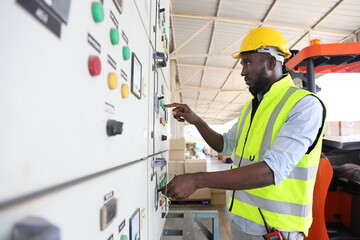 African American engineer is checking for power at main distribution board for the circuit at the factory site electricity maintenance