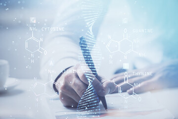 Man's hands working with notes background. Genetic engineering and gene manipulation concept.