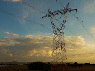 red and white electricity tower with sunsets