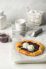 Plum jam galette served with scoop of ice cream.