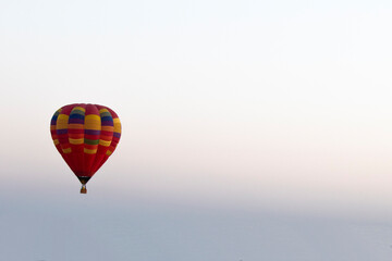 Hot air balloon over the field with blue sky