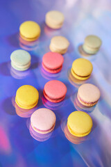 French cake macaron. Set of cute sweets on colorful rainbow background. almond cookies, pastel colors, top view