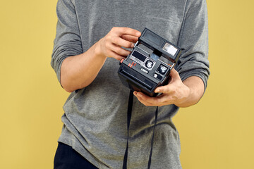 Photo camera in the hands of a man professional equipment hobby Creative approach studio cropped view