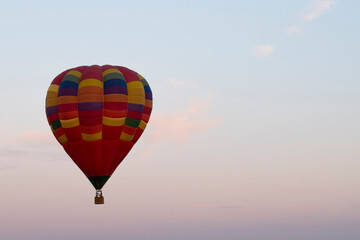 Hot air balloon over the field with blue sky