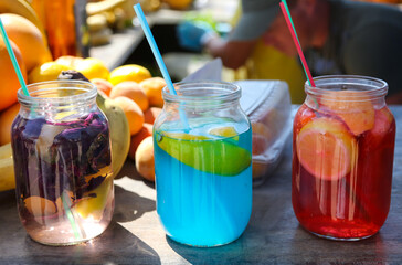 Three different cocktails in cans at the bar.