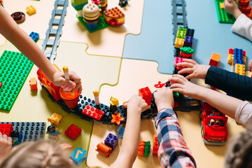 Educational toys for preschool and kindergarten child. Child playing with constructor blocks at class.