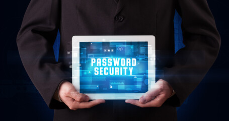Young business person working on tablet and shows the digital sign: PASSWORD SECURITY