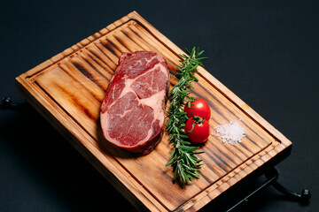 Rib eye steak on a black background.