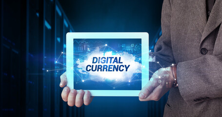 Young business person working on tablet and shows the inscription: DIGITAL CURRENCY