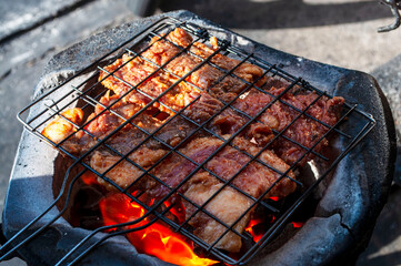 Roasted beef on charcoal grilled Isan Thai food that is bold and delicious.