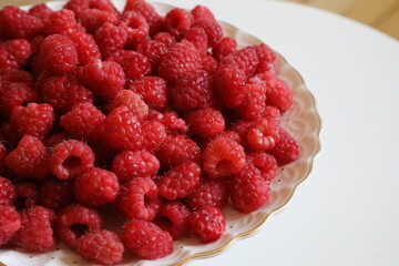 Big Pile of Fresh Raspberries in the White Bowl Isolated on the White Background