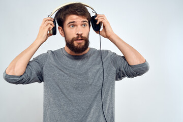 Man in headphones listens to music lifestyle leisure light background