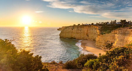Natural caves and beach, Algarve Portugal. Rock cliff arches of Seven Hanging Valleys and turquoise...