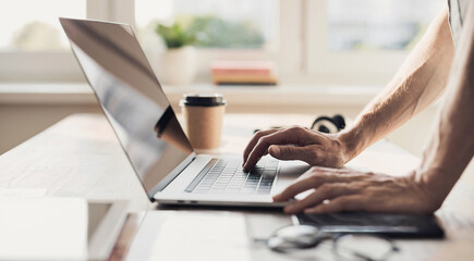 Fototapeta premium Man hands typing on computer keyboard closeup, businessman or student using laptop at home, panoramic banner, online learning, internet marketing, working from home, office workplace freelance concept