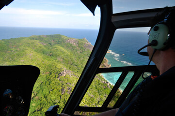 La Digue Island / Seychelles - August 3 2010: tropical island view through the helicopter window with the pilot © MF1688