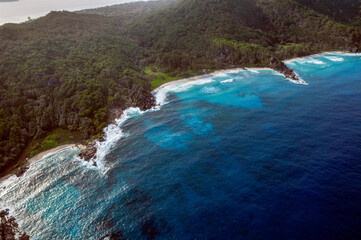Fototapeta na wymiar Aerial view of a tropical island with coastline and blue ocean. La Digue Island, Seychelles