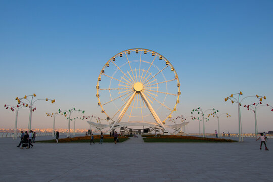 Ferris wheel on the background of blue sky. Boulevard National Park of Baku.