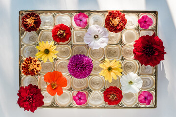 summer collection of flowers in a candy box
