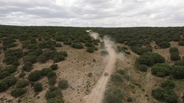 Aerial view of SUV racing car in the desert of international Dakar rally event