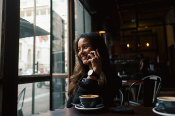 Young woman in coffee shop smiling