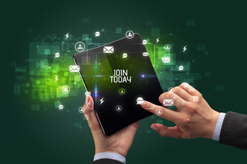 Businessman holding a foldable smartphone with JOIN TODAY inscription, social networking concept