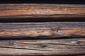 Wall of an old house made of pine logs
