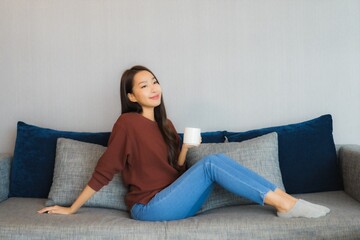 Portrait beautiful young asian woman relax smile on sofa