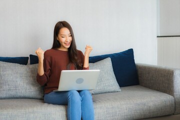 Portrait beautiful young asian woman use computer laptop on sofa