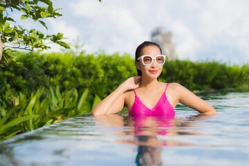 Portrait beautiful young asian woman relax enjoy around outdoor swimming pool