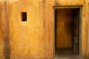 Fototapeta na wymiar Open door with yellow wall at Amber Palace in Jaipur, India