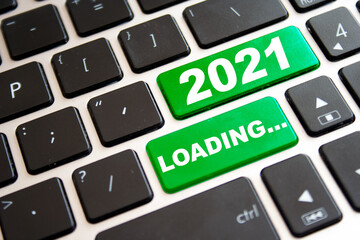 Note year 2021 LOADINGwritting on green button on computer keyboard. New year