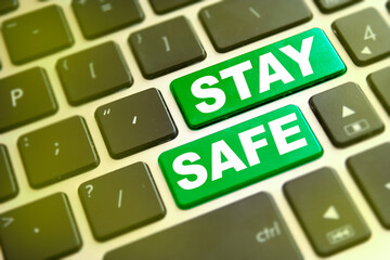 Note STAY SAFE writting on green button on computer keyboard. Stay safe key on computer keyboard prevention message