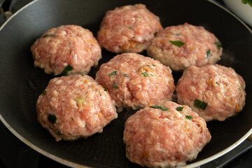 Preparation of cutlets from ground meat on pan.