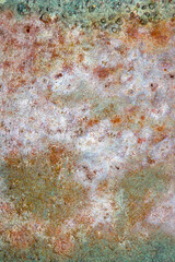 Textured surface of green metal barrel with rust