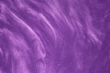de-focused. Abstract elegant, detailed purple glitter particles flow underwater. Holiday magic...