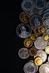 Swiss franc coins lie on a dark background.