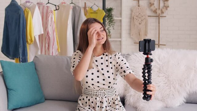 Cute Lady in a Dress Takes Pictures of Herself. Charming Blogger Shares the News With Her Followers for Creating a New Content for Beauty Video Blog