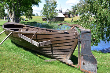 Fishing boat with a rudder on the bank pulled out for drying
