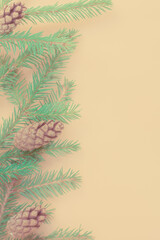 Composition with a decorated Christmas tree on a beige background with space for text. Christmas layout or greeting card. The view from the top.