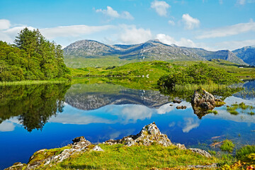 Awe inspiring landscape and lake reflecting Connemara National Park in Ireland