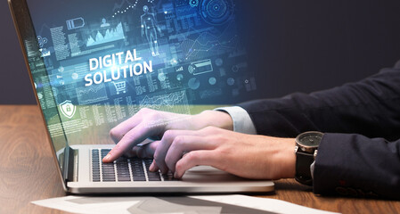 Fototapeta na wymiar Businessman working on laptop with DIGITAL SOLUTION inscription, cyber technology concept