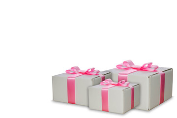White gift boxes with a pink ribbon isolated on a white background, celebration season concept