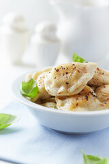 Dumplings with potato and cottage cheese stuffing (pierogi). Traditional Polish Christmas Dinner. Bright background.	