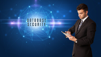 Businessman thinking about security solutions with DATABASE SECURITY inscription