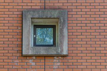 Small window in a red brick wall