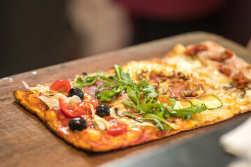 Pizza slices served on a wooden board.