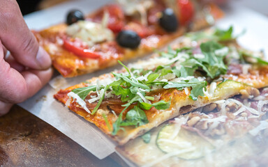 Pizza slices served on a wooden board.